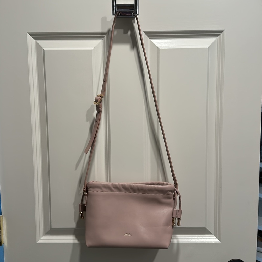 A.P.C. Cross body, blush pink color bag with rose gold hardware.